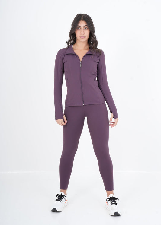 Woman wearing a purple athletic outfit on a white background