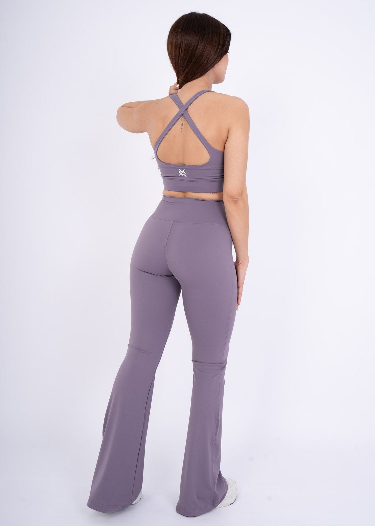 Women's VAN MILE Reborn Flared Leggings in Purple – back view, shown with matching sports bra