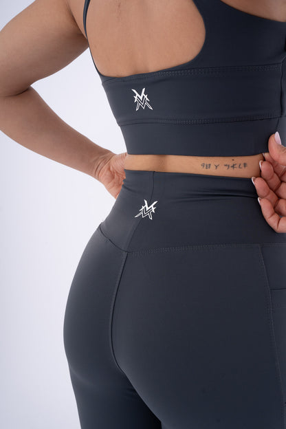 Women's VAN MILE Reborn Sports Bra in Dark Grey – back logo detail, shown with matching leggings