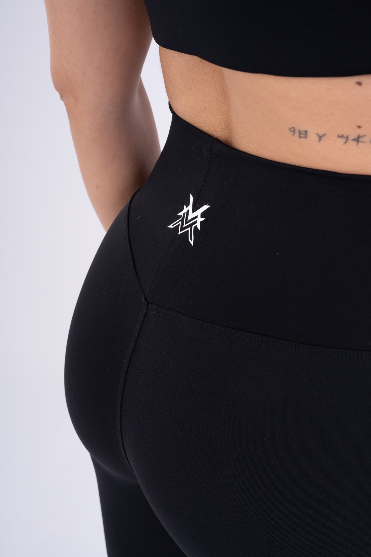 Women's VAN MILE Reborn Leggings in Black – logo detail on back waistband