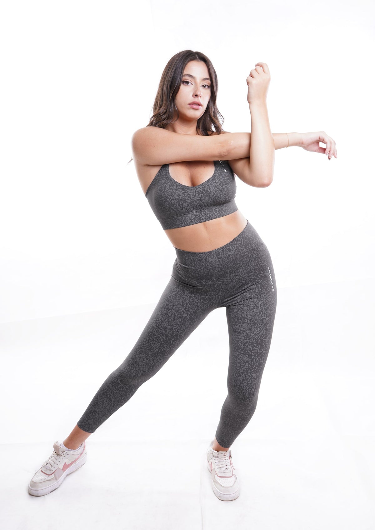 Women's VAN MILE Journey Leggings in Grey – full-length stretching pose, shown with matching sports bra