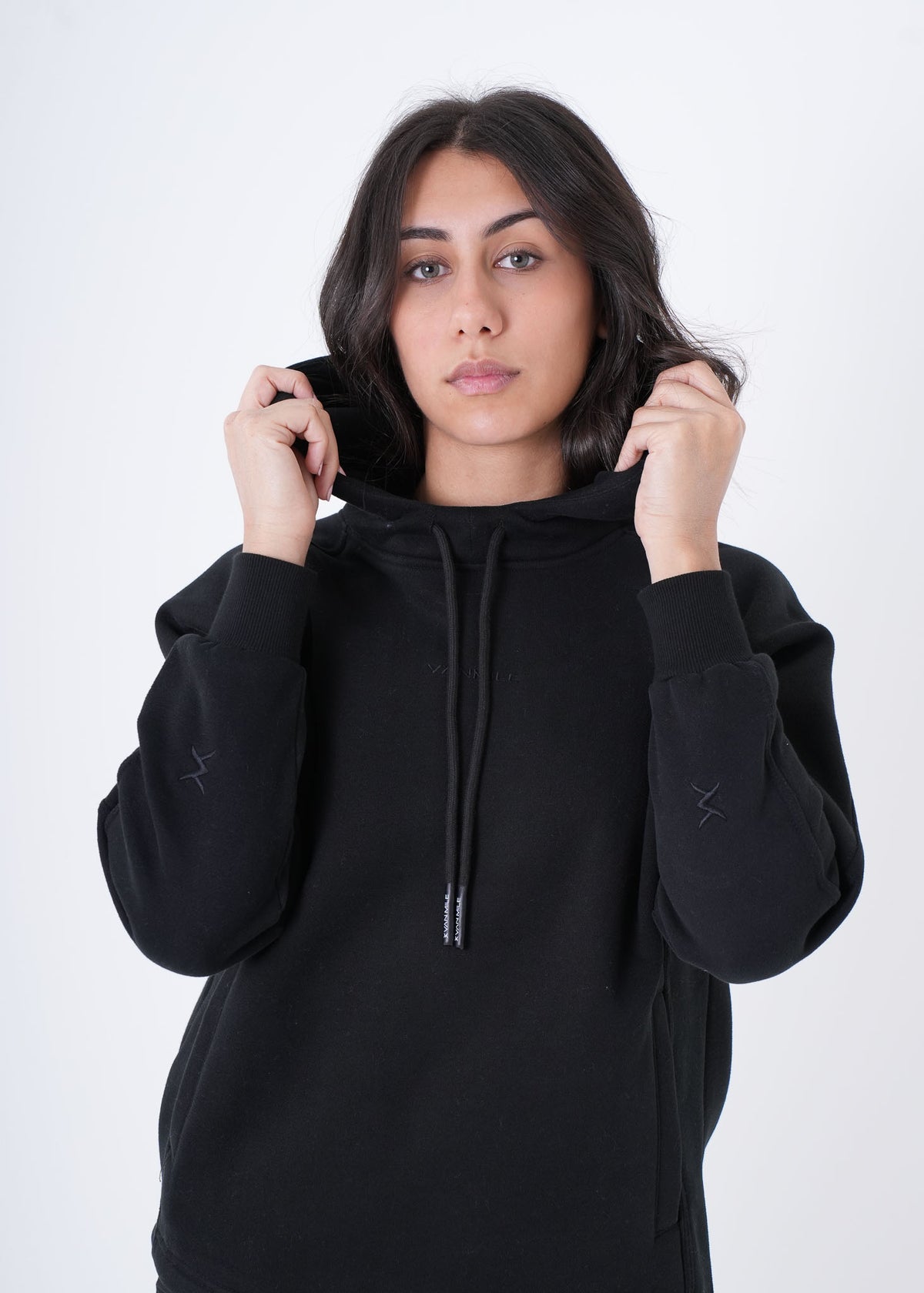 Women's VAN MILE VNML Hoodie in Black – front view, holding the hood