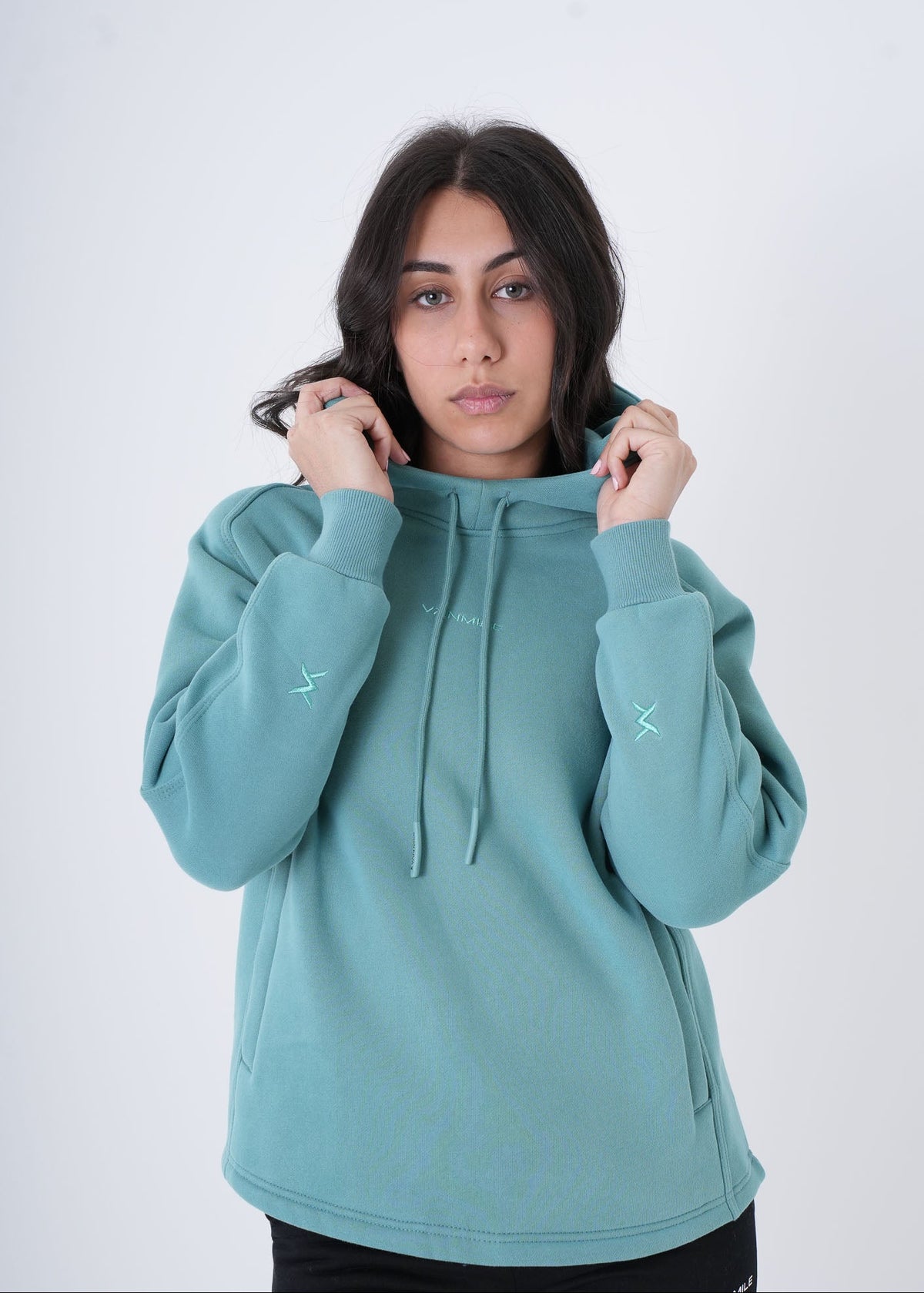 Women's VAN MILE VNML Hoodie in Turquoise – front view, holding the hood