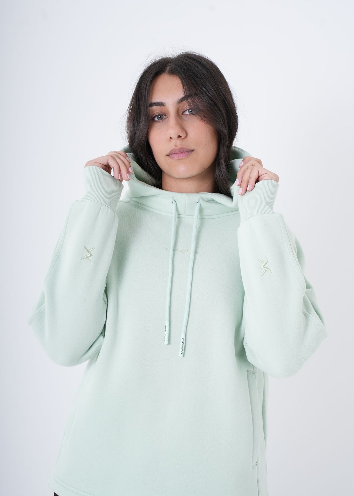 Women's VAN MILE VNML Hoodie in Mint Green – front view, holding the hood