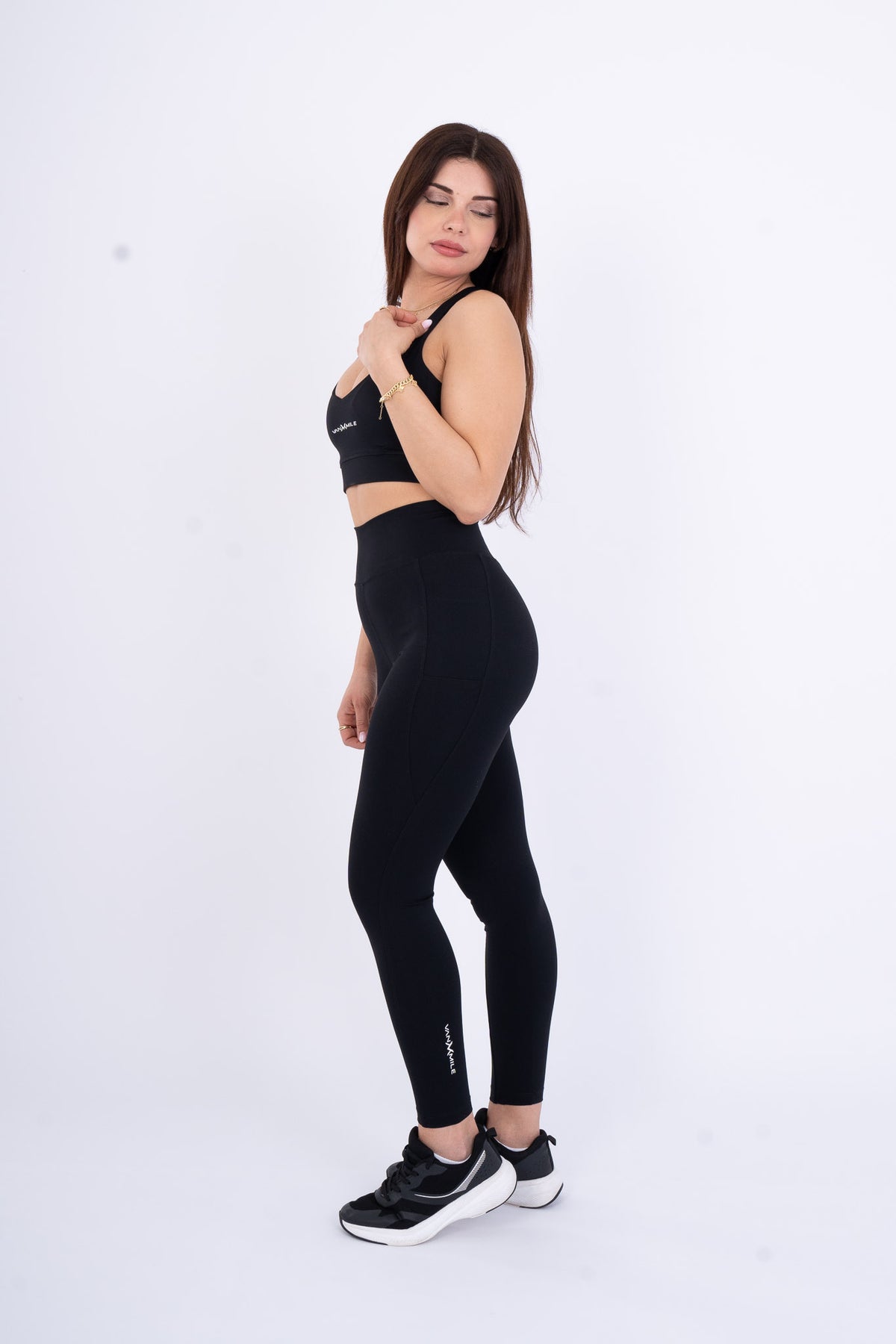 Women's VAN MILE Reborn Sports Bra in Black – side view, shown with matching leggings