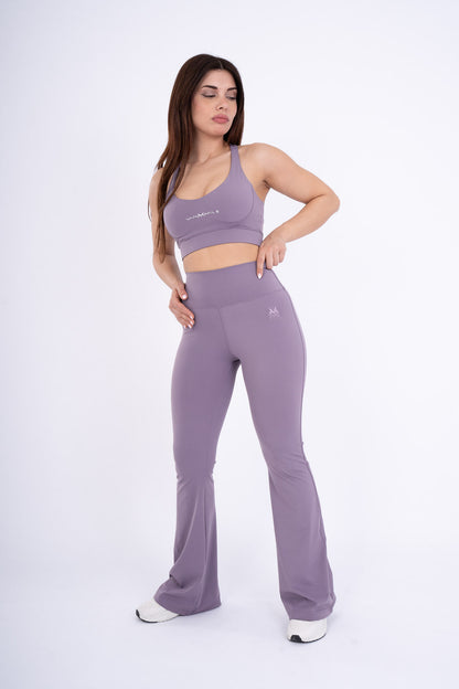 Women's VAN MILE Reborn Flared Leggings in Purple – angled front view, shown with matching sports bra