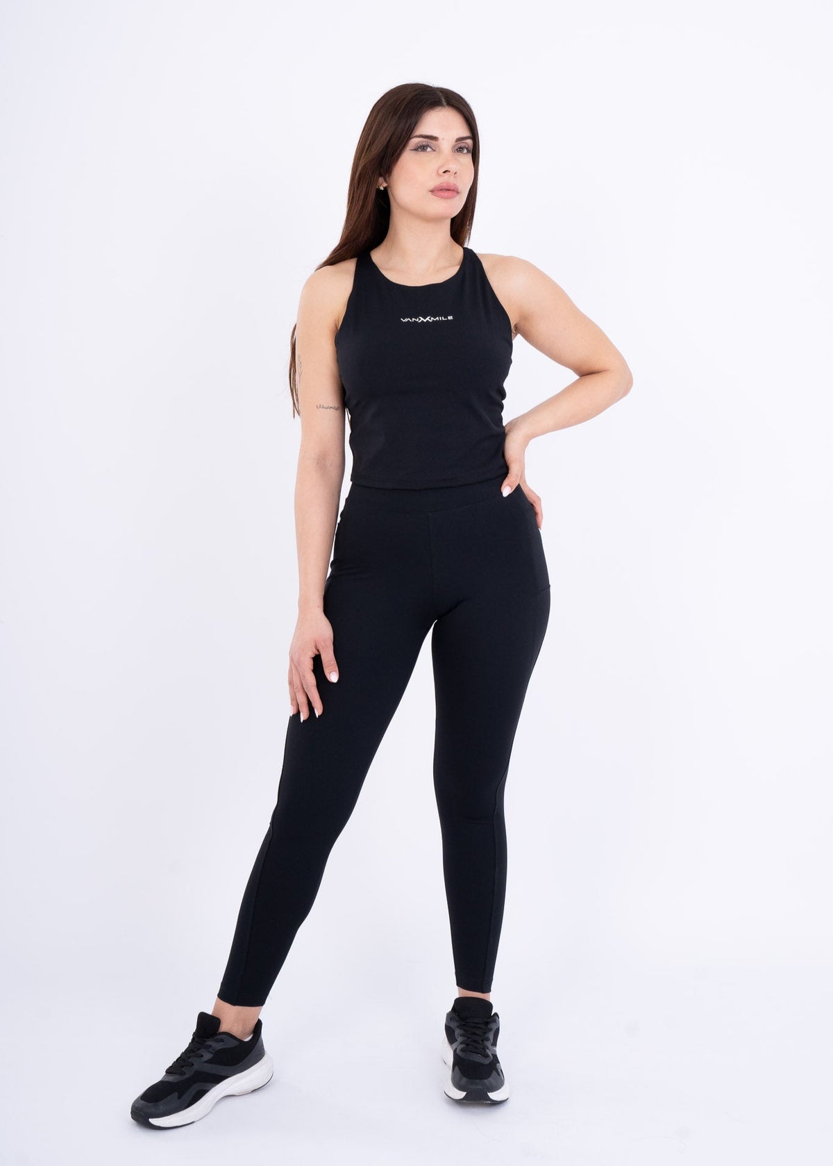Women's VAN MILE Reborn Top Double X in Black – front view, worn with black leggings