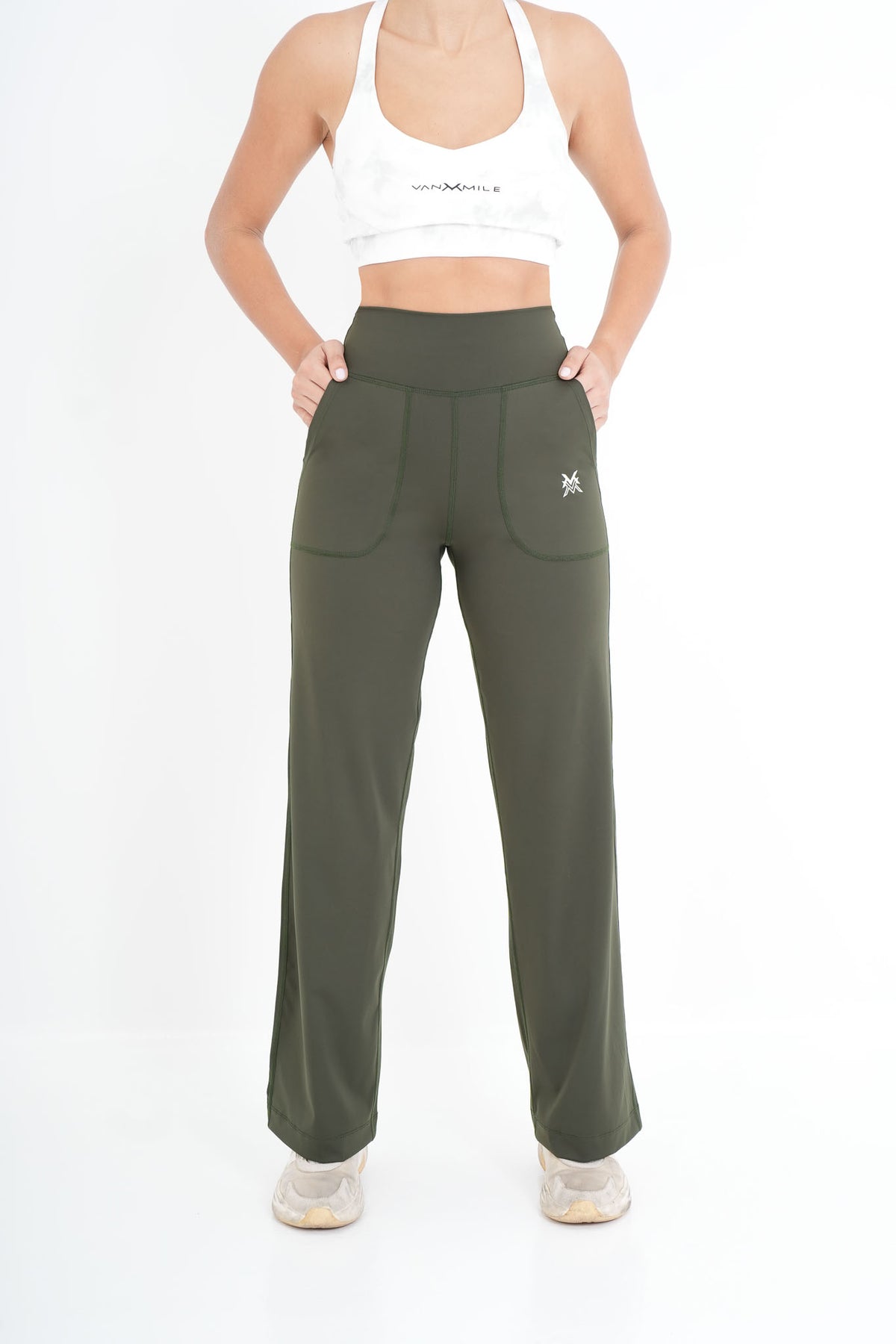 Women's VAN MILE PULSE Flared Leggings in Olive Green – front view, hands in pockets