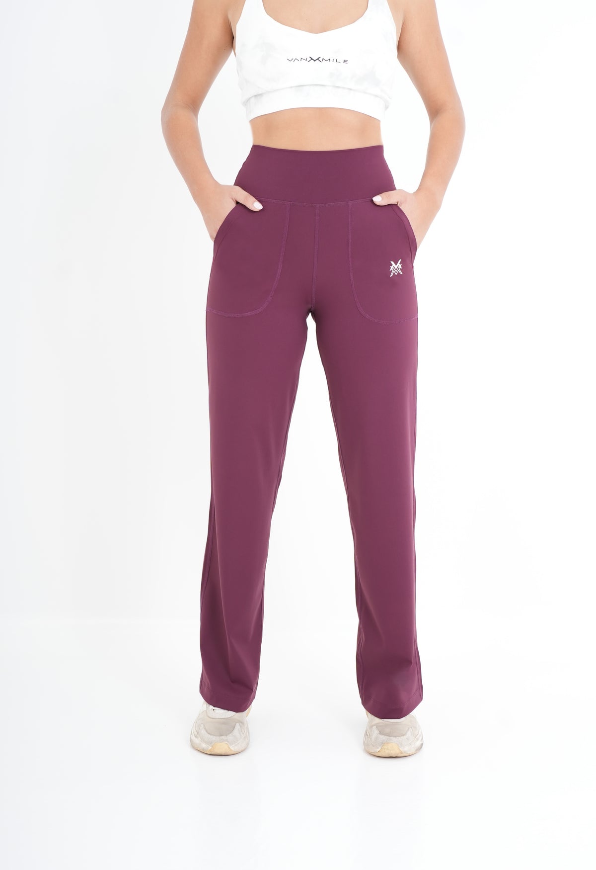 Women's VAN MILE PULSE Flared Leggings in Ruby – front view, hands in pockets