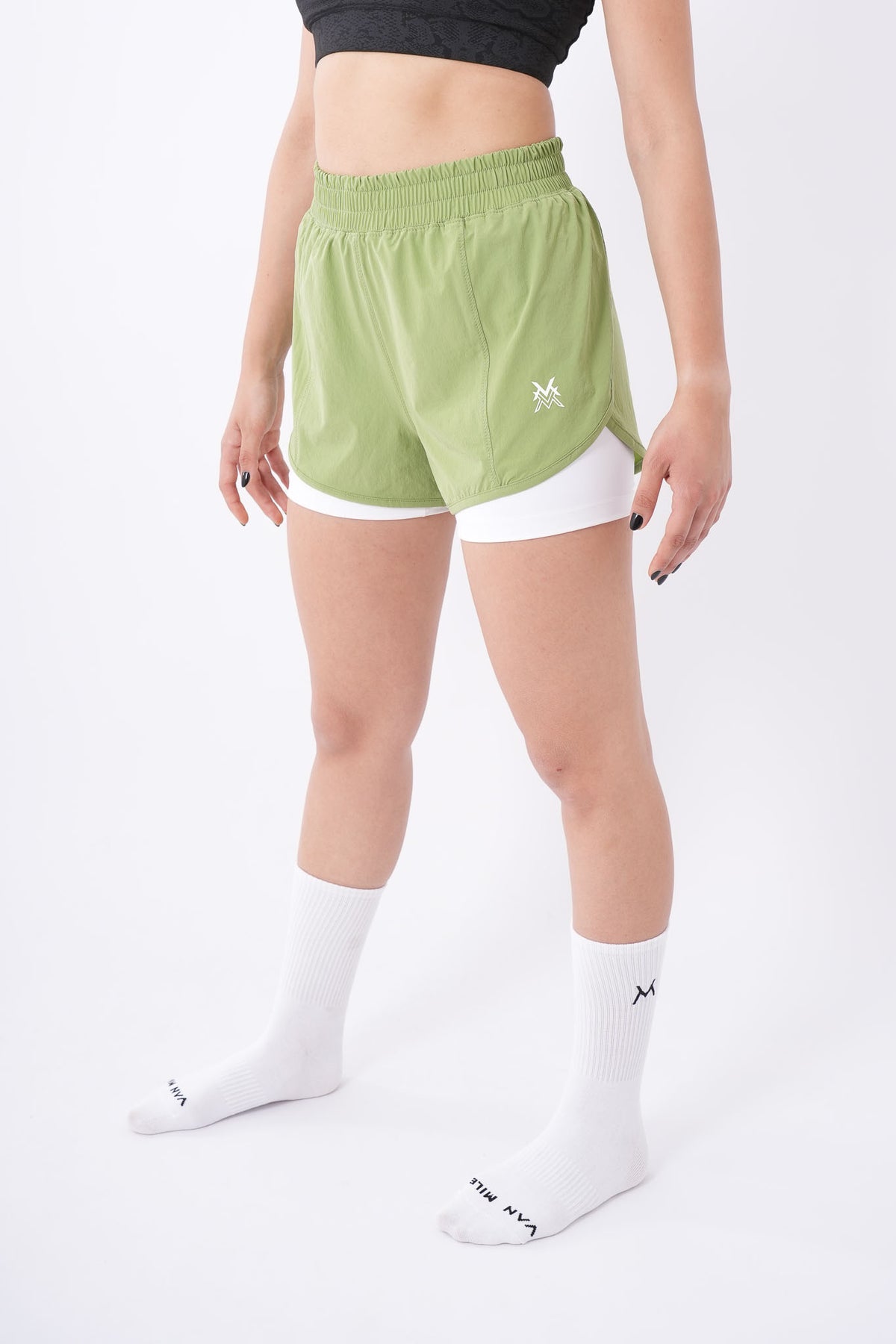 Women's VAN MILE Aurora Compression Shorts in Lime Green with White Liner – angled front view, full length