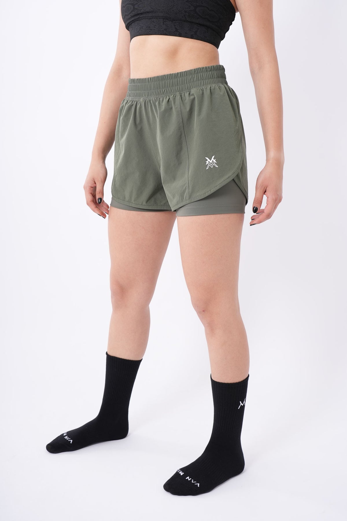 Women's VAN MILE Aurora Compression Shorts in Olive Green – angled front view, full length
