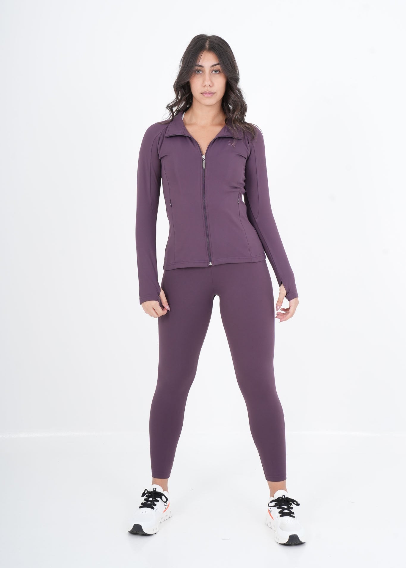 Woman wearing a purple athletic outfit on a white background