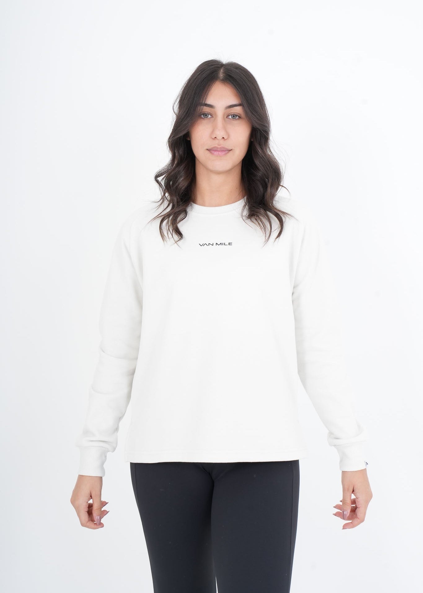 Woman wearing a white long-sleeve shirt with text on a white background