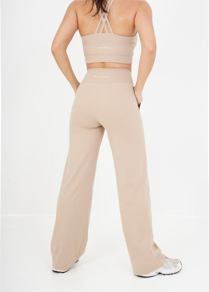 Women's VAN MILE Sculpt Flared Leggings in Beige – back view, shown with matching bra