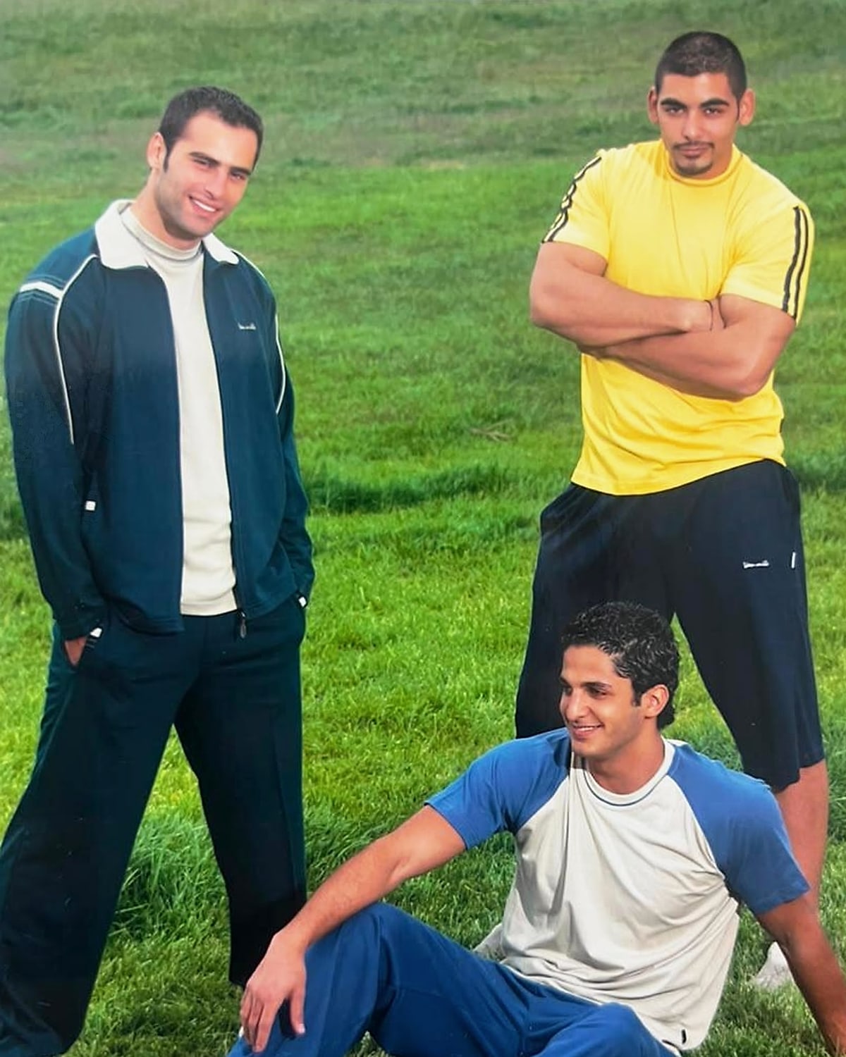 Archive VAN MILE photo: three men in VAN MILE tracksuits and training tees on a grass field
