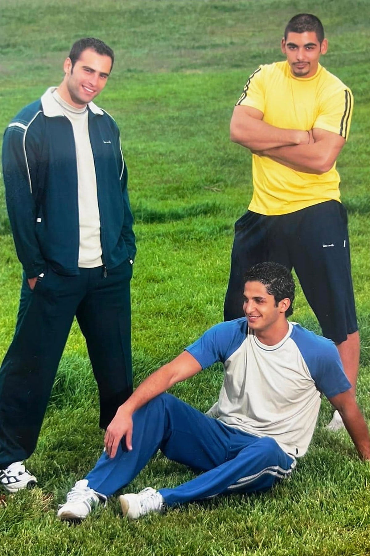 Archive VAN MILE photo: three men in VAN MILE tracksuits and training tees on a grass field