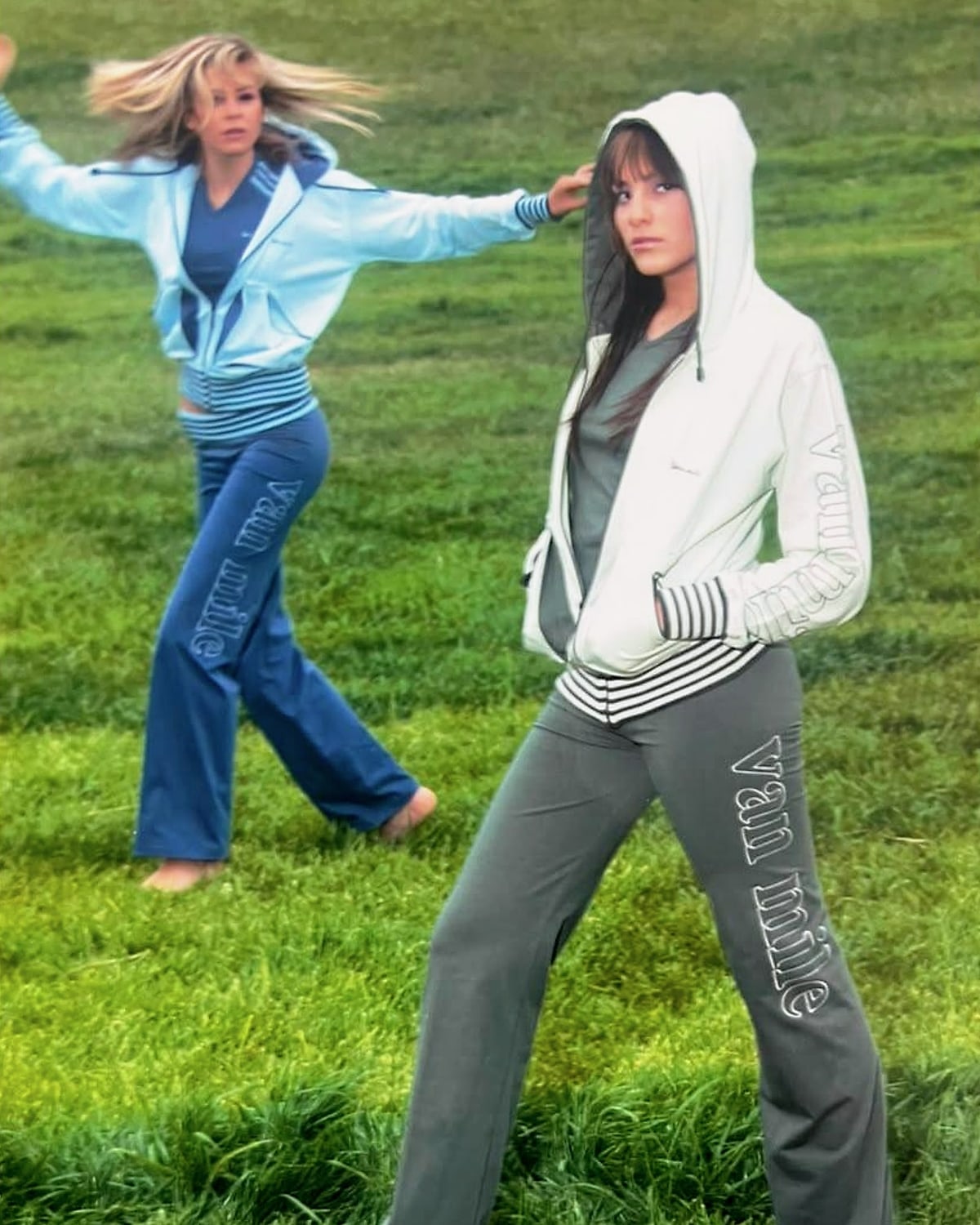 Archive VAN MILE photo: two women in VAN MILE zip hoodies and logo track pants on a grass field