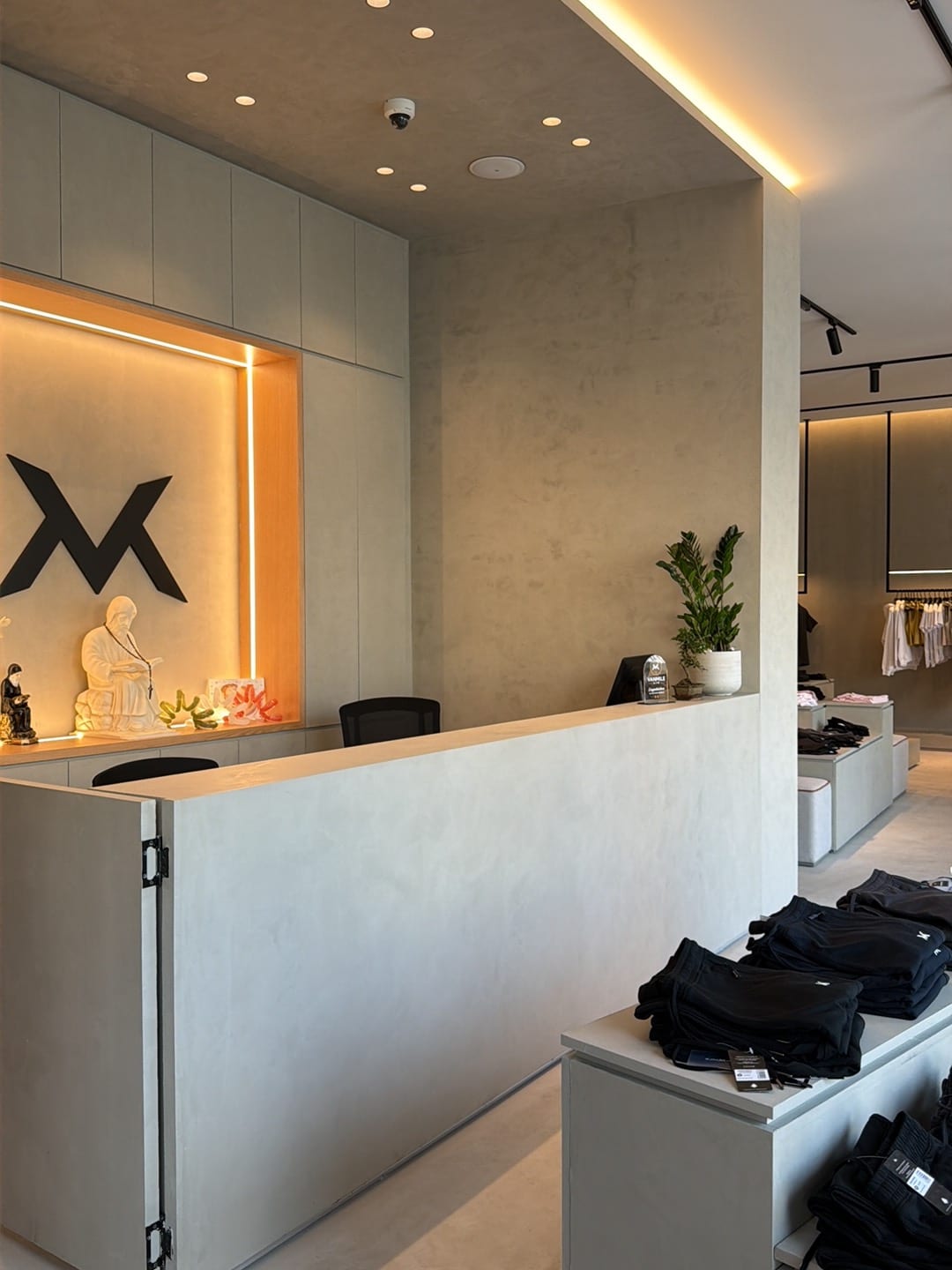 VAN MILE showroom reception with the VM logo