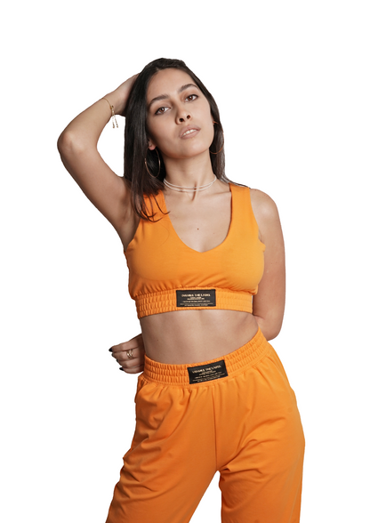Women's VAN MILE Lounge Bra in Melon Orange – front view, worn with matching joggers